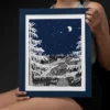 Autumn Before Dawn part of the Vintage Series by Line & Blossom Design in a Navy blue frame held by a seated smiling woman